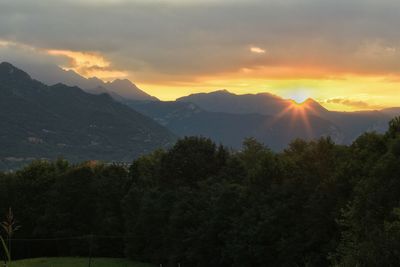 Scenic view of mountains against sky at sunset