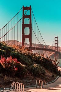 View of suspension bridge against clear blue sky