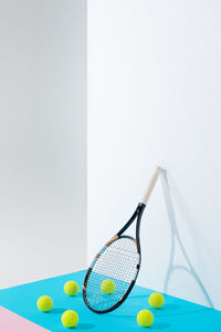 Tennis racket and balls on table