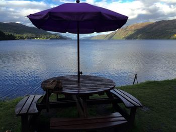 Empty bench in calm lake