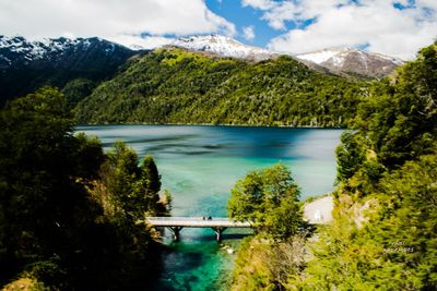 Scenic view of lake and mountains against sky