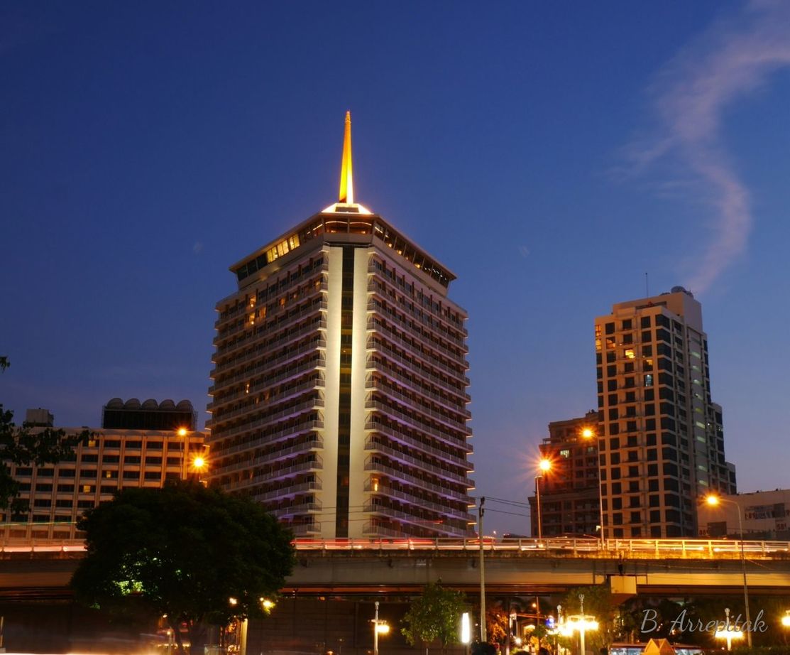 LOW ANGLE VIEW OF ILLUMINATED CITYSCAPE AGAINST SKY