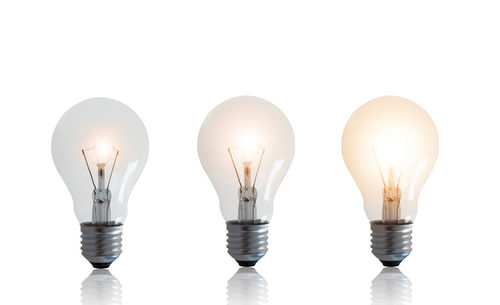 Digital composite image of light bulb against white background
