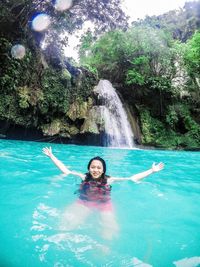 Portrait of smiling woman in swimming pool