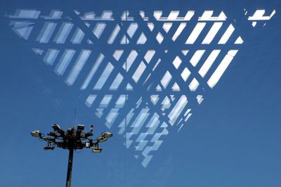 Low angle view of windmill against blue sky