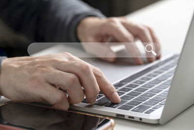 Midsection of man using laptop