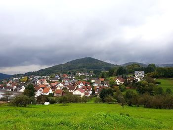 Town by mountains against sky