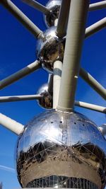 Low angle view of pipe against blue sky