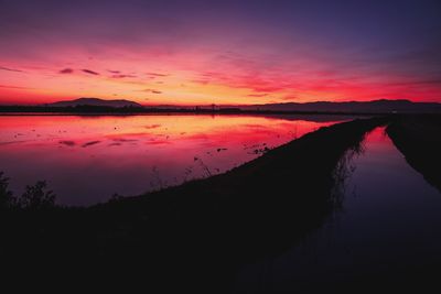 Scenic view of lake against romantic sky at sunset