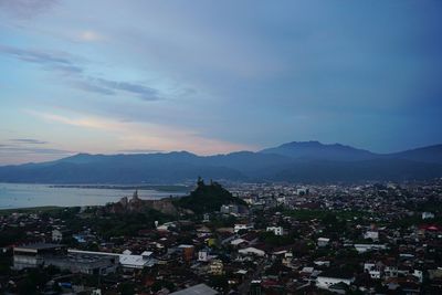 High angle view of townscape and mountains against sky