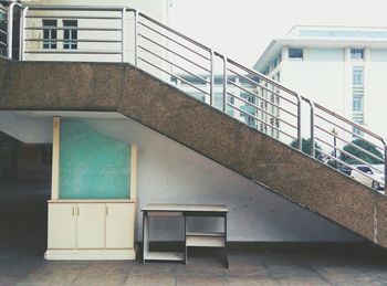 Table under staircase in city