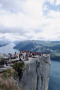 People on mountain against sky