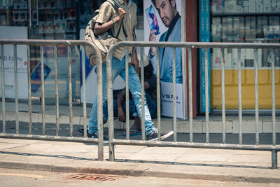 Low section of people standing on footpath