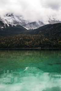 Scenic view of lake and mountains against sky