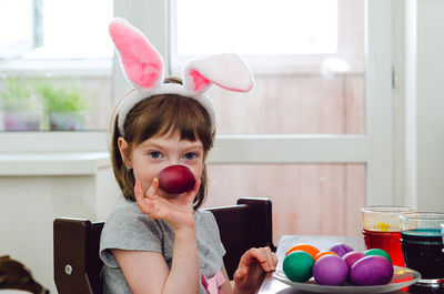 A little girl is painting eggs for the easter holiday.