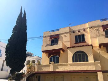 Low angle view of building against clear blue sky