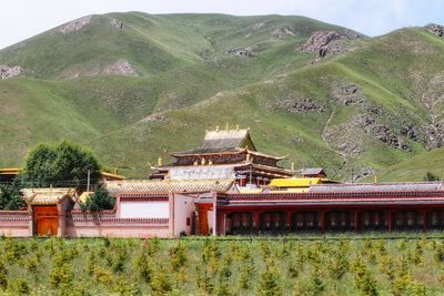 Traditional building on mountain against sky