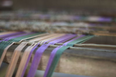 Close-up of colorful threads on loom