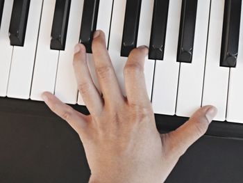 Midsection of man playing piano