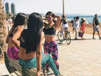 Rear view of people on bicycle in city