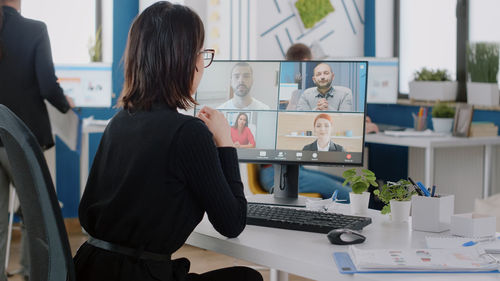 Businesswoman talking on video call at office
