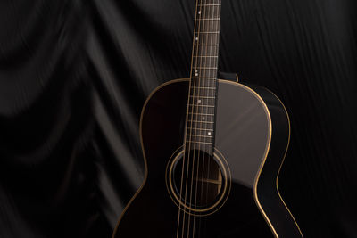 High angle view of guitar on bed