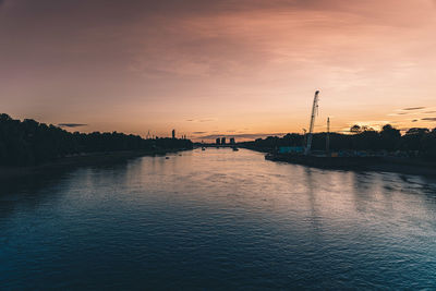 Scenic view of river against sky during sunset