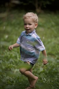 Full length of cute boy standing on field