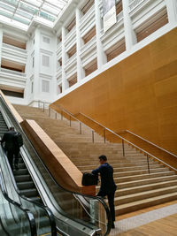 High angle view of man standing on staircase in building