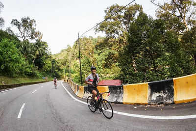 Man riding bicycle on road