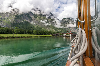 Scenic view of lake by mountains against sky