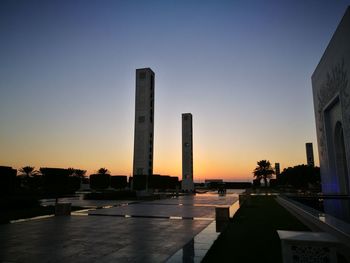 Silhouette buildings against clear sky during sunset