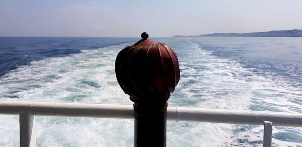 Rear view of man looking at sea against sky