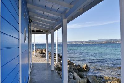 Blue beach hut by sea