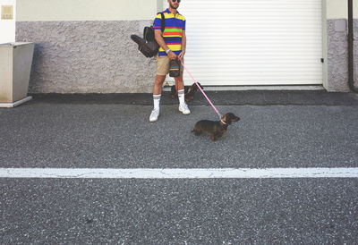 Low section of woman walking on street