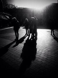 Shadow of people walking on city street