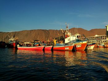 Boats on shore against sky