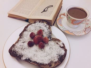 High angle view of breakfast and book on white background