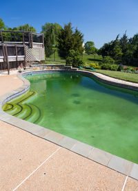 View of swimming pool by lake against sky