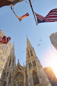 Low angle view of flags in temple against sky