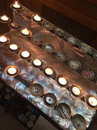 Low angle view of illuminated lighting equipment