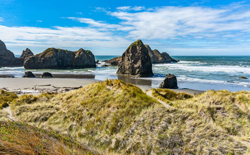 A view of meyers creek beach with waves and rock formations on the coast of oregon state.