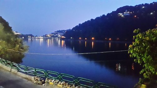 Scenic view of lake against clear sky at night
