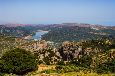 Scenic view of landscape and mountains against clear sky