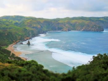 View of beach against cloudy sky