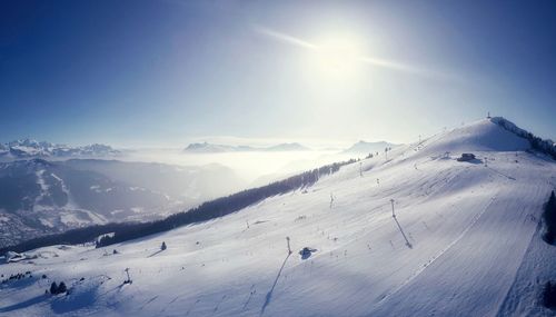 Scenic view of snow covered field against sky