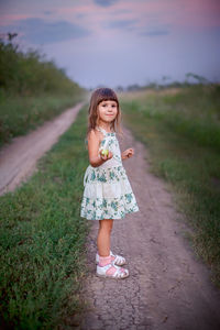 Portrait of a smiling girl standing on land