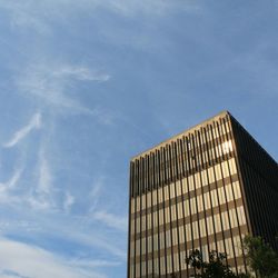 Low angle view of building against cloudy sky