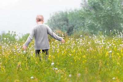 Rear view of man standing on field