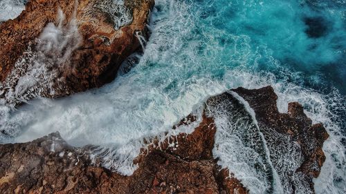 High angle view of rock formation in sea